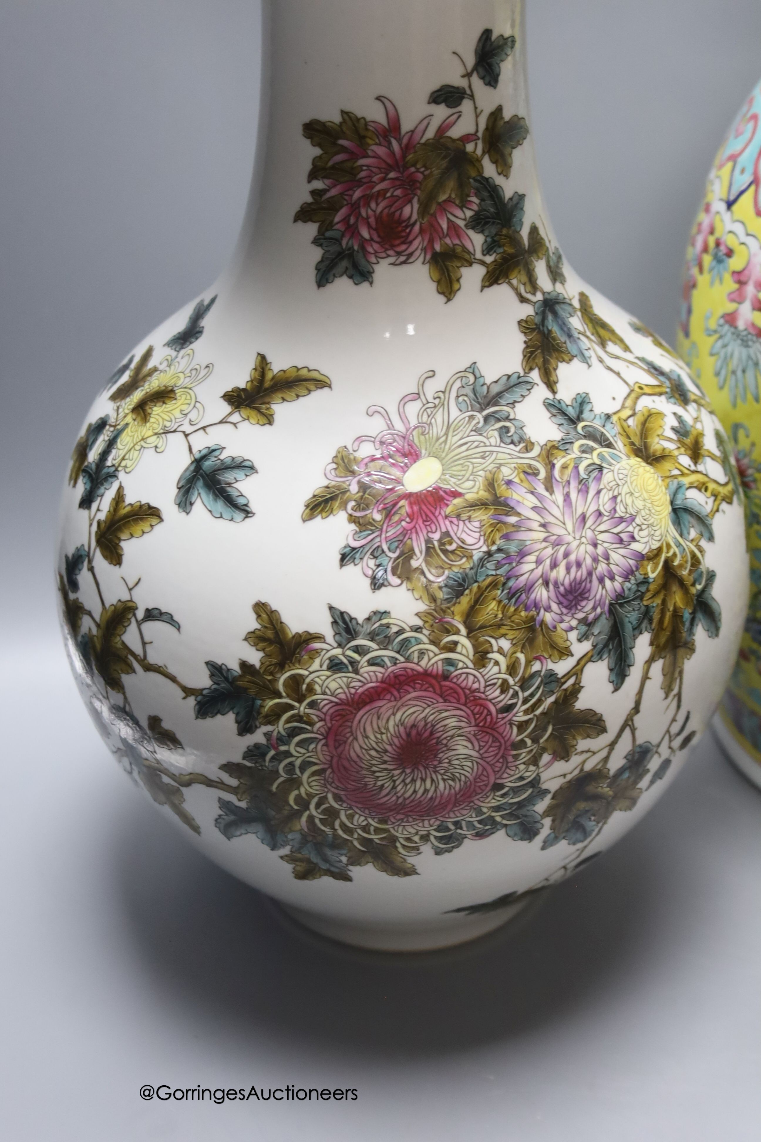 A Chinese yellow ground vase and another painted with chrysanthemums, tallest 46cm